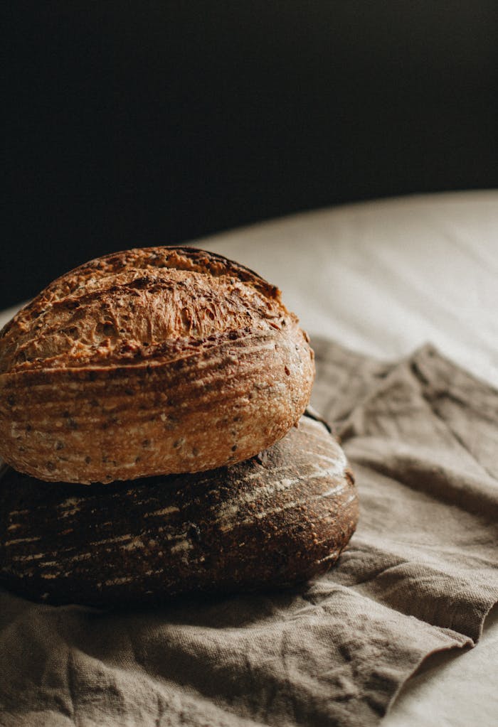 Warm artisan sourdough loaves placed on rustic linen for a homemade touch.
